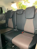 Black and brown covers fitted to the Kia Carnival third-row bench